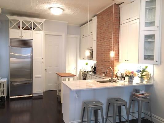 Kitchen in unit one, marble tops, faux brick wall installed, good quality cabinets, countertops