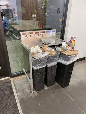 Full trash bins inside and outside