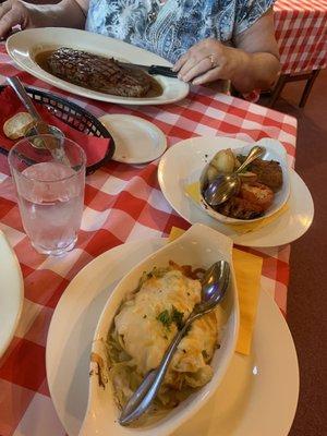 Steak, mashed potatoes and other vegetables.