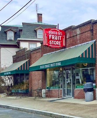 Storefront with iconic red sign and green awning