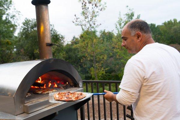 Baking pizzas at the Green Bay Botanical Gardens during a concert.