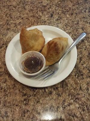 Samosas- come as a pair.   Spicy potato dumpling in dough shell and served with yogurt chatni.