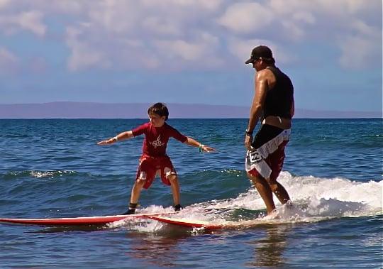 Brady Wells and coach Brian sharing a fun wave.