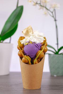 Bubble waffle with ube ice cream, whipped cream and a toasted marshmallow.