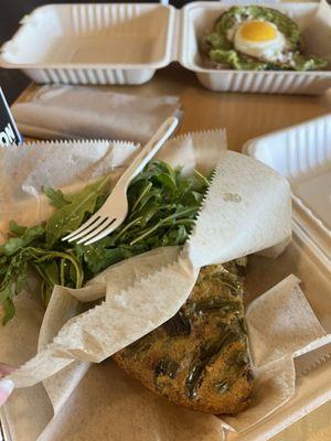 Garden Frittata with greens, avocado toast with sunny side up egg in the back