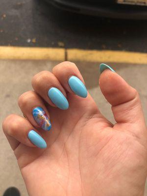 Beautiful almond manicure with marbled and gold leaf  party nail.