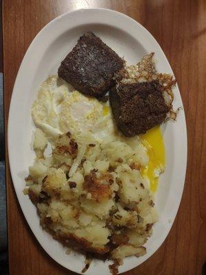 Scrapple, eggs and home fries with onions.