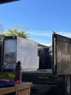 REFRIGERATOR, MASSAGE CHAIR, GRILL LOADED ONTO THE TRAILER