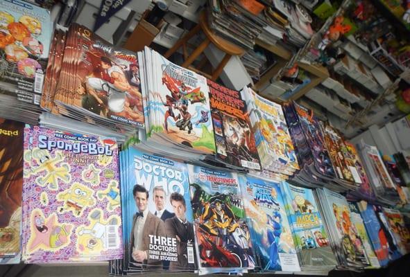 Array of free comics available to choose from. Three per person, please.