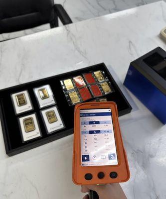 Testing gold bars with a XRF element analyzer.