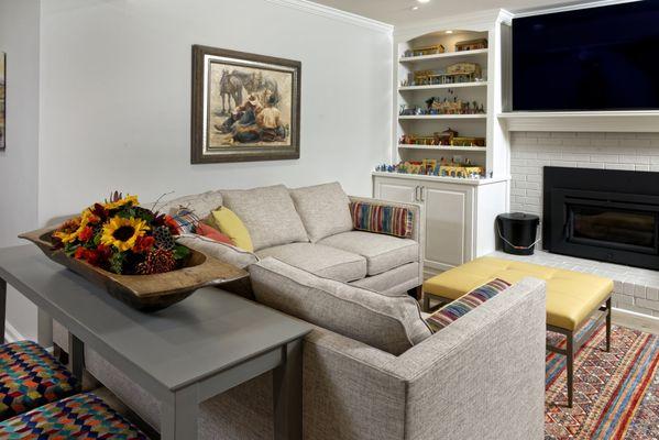 This Basement Rec Room transformation was inspired by a client's collection of Western toy sets, influencing all color and design choices.