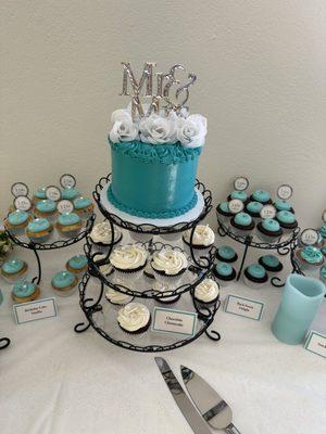 Beautifully arranged cake and cupcakes all Tiffany inspired.