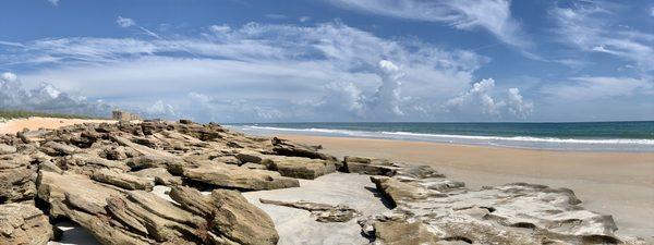 Beach in front of rocks at low tide