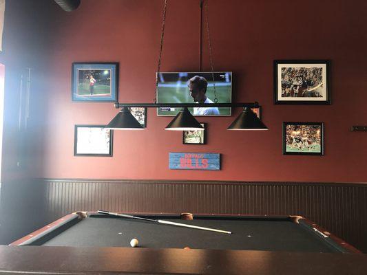 Pool table, 1 of the flat screens and lots of memorabilia! There's also a coat rack to the right.