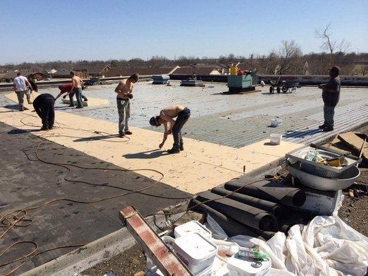 Re-roofing Sunshine Furniture in Tulsa, OK. 130,000 sq. ft. using multi-ply roofing system with tar and river rock.