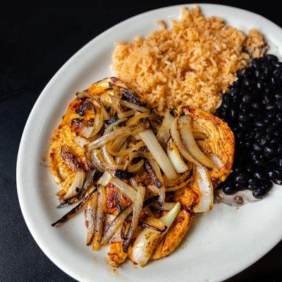 Come try our pollo ala plancha! Grilled chicken breast topped with grilled onion served with rice and black beans