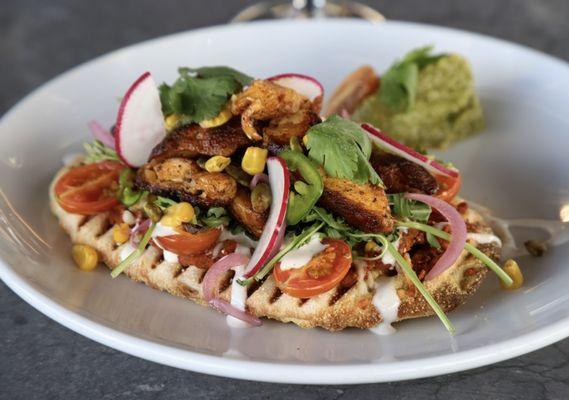 Chicken Huarache (Flatbread) chipotle red bean puree, arugula, veggies, cilantro lime crema, cotija cheese, and tomatillo avocado salsa