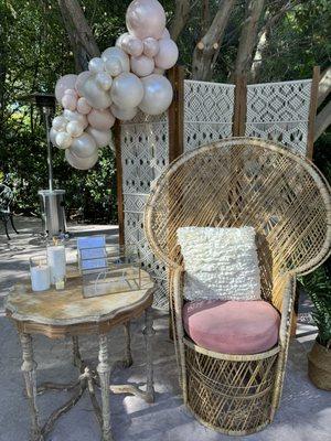 Our peacock chair with cushion, accent pillow, wood side table, candles, card box, machrome 3-panel screen.