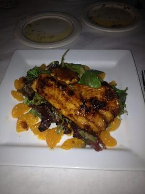 Blackened spicy mango tilapia over field greens