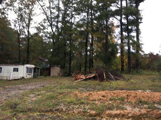 Burn pile and mobile home for sale out the front.