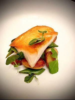 Sable fish, marble potatoes, sugar snap peas with a soubise sauce.