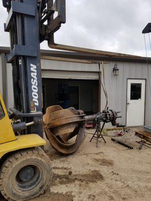 Unloading large grapple from West Texas scrap yard for repair and rebuild.