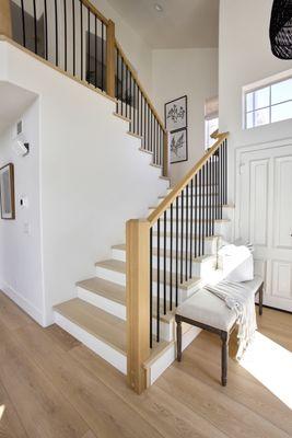 Stain grade beveled top post, Solid White oak treads, 6084 handrail and black iron bars