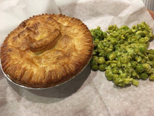 Steak and onion pie with a side of mushy peas