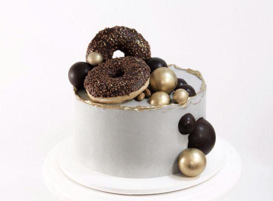 Sponge cake, decorated with chocolate balls and our special donuts