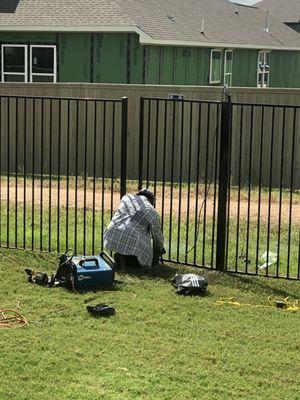 Worker installing the new gate