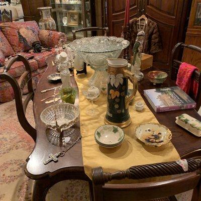 Kitchen table with dishes and glasses on display.