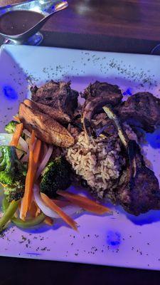 Lamb chops, rice n peas with vegetables.