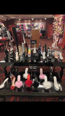 Stripper heels, and behind them, the general merch and party/game supplies.