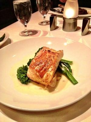 Sea bass with broccolini and sauce.