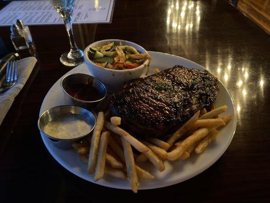 Steak, fries and sautéed vegetables (zucchini, bell peppers, cabbage).