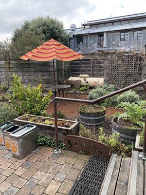 Outside back garden at Brickmaiden has five or six patio tables. And they recycle!