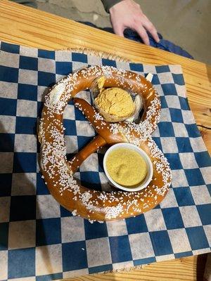 Pretzel with mustard and cheese