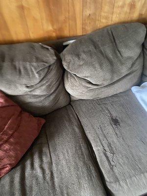 The extremely worn couch