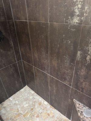 Shower wall, floor, and seat.