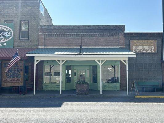 Front of the shop, between A Ave and B Ave.