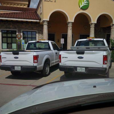 June 30th 4:28 PM Employee trucks parked for more than 15 minutes in customer parking with License Plate numbers.