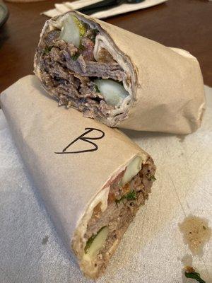 Tut wrap (beef shawerma): seasoned grilled beef strips with parsley, pickles, tomatoes & onions