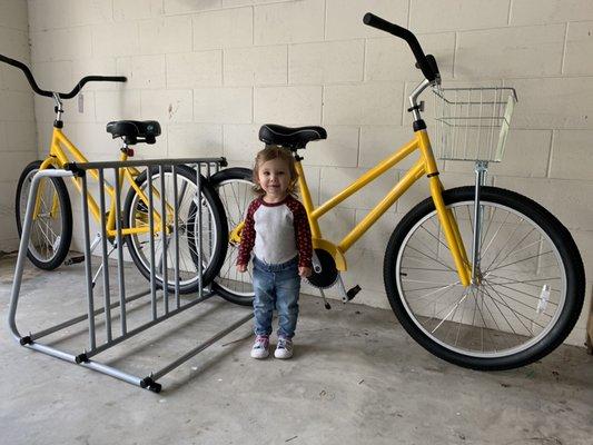 Ella learning the bicycle business with daddy.