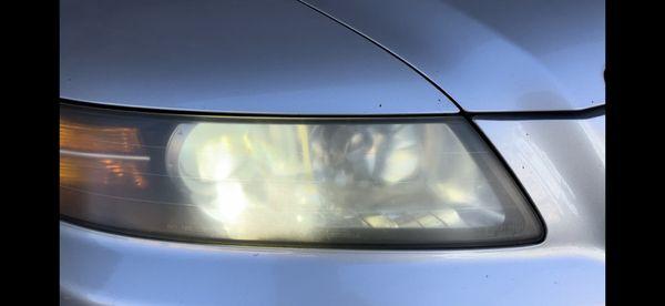 Closeup of the hazy headlight before headlight restoration.