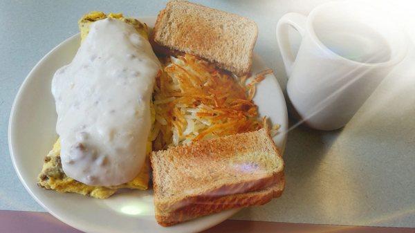 Great choice putting sausage gravy over a bacon omelette with hash browns and wheat toast. And of course that side if coffee.