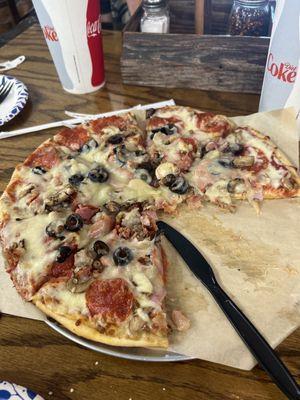 Meat pizza with mushrooms and black olives