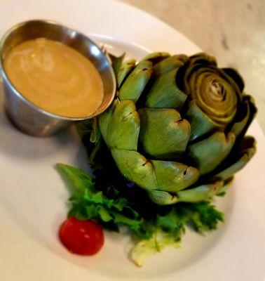 Warm steamed whole artichoke