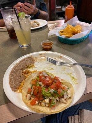 Corn chips with salsa, beans with Diablo sauced rice, Tacos Mexicana, and 1800 Cadillac margarita