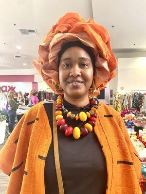 Showing the Mudcloth shawl, amber beads, African scarf by our beautiful model Ina