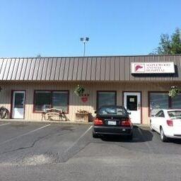 Our clinic, complete with cheerful hanging baskets plenty of parking and  a little dog walking area on the side.